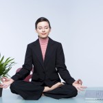 Young business woman doing yoga